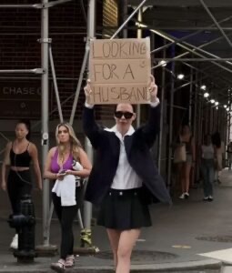 Woman walks around street with giant sign that reads ‘looking for a husband’ – then the unexpected happens